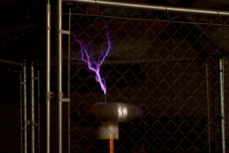 a purple lightning bolt coming out of a metal pipe