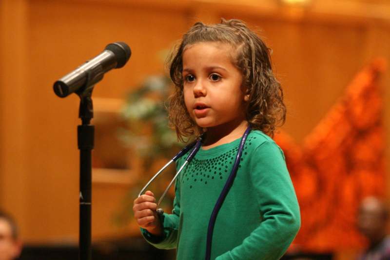 a young girl with a stethoscope around her neck