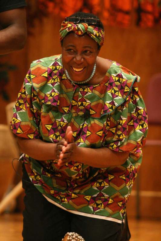 a woman in a colorful shirt and head wrap