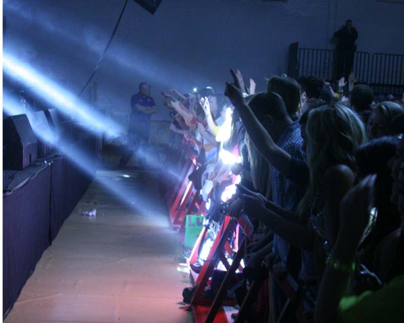 a group of people on a stage with a spotlight