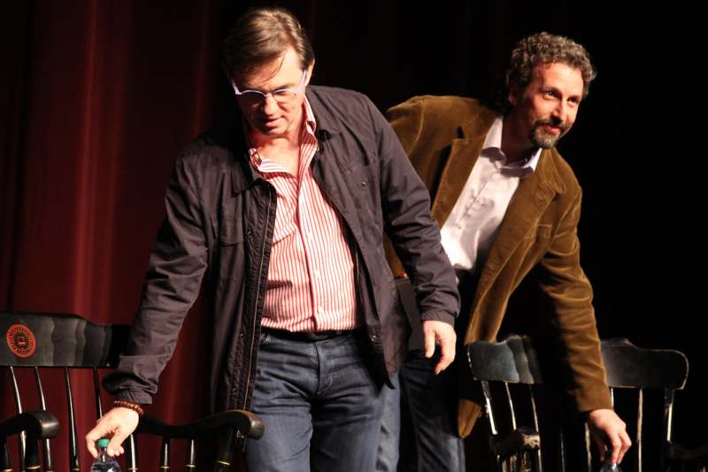 two men walking on a stage