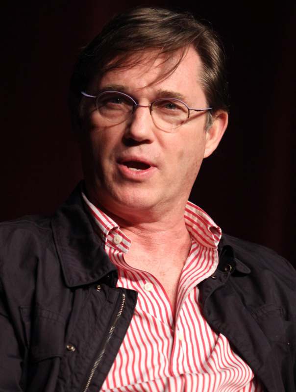 a man wearing glasses and a black jacket