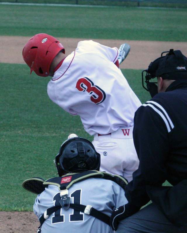a baseball player in a red uniform and helmet