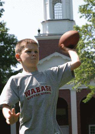 a young boy throwing a football