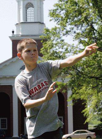 a boy throwing a frisbee