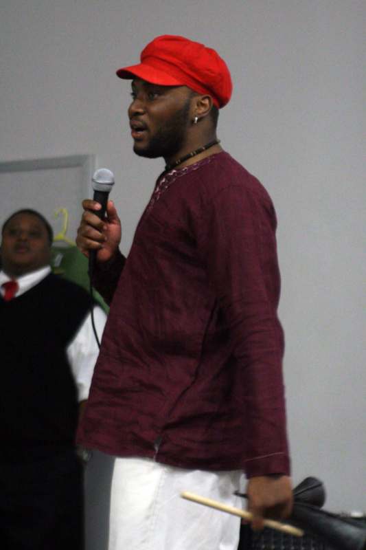 a man in a red hat holding a microphone