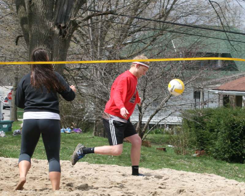 a man and woman playing volleyball