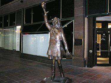 a statue of a woman holding a rose