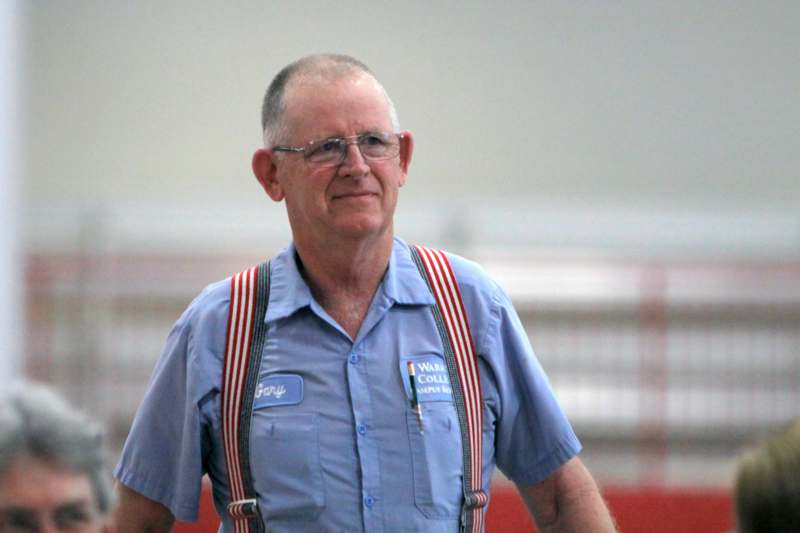 a man wearing suspenders and a blue shirt