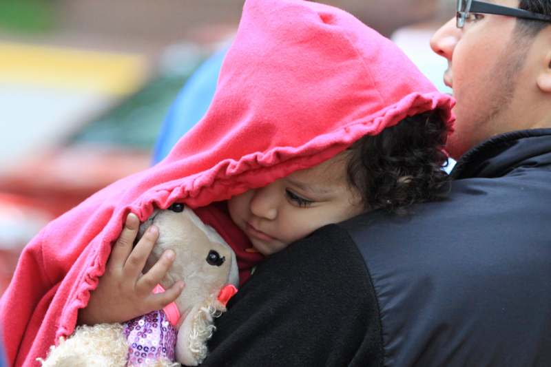 a child holding a stuffed animal