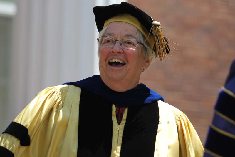 a woman wearing a graduation gown