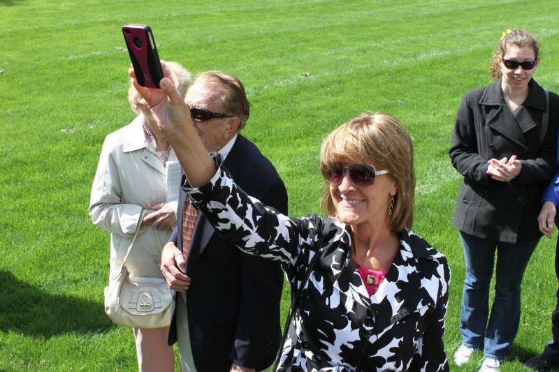 a woman taking a selfie with a cell phone