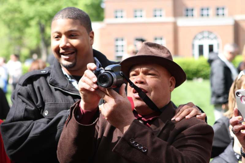 a man holding a camera and another man holding a camera