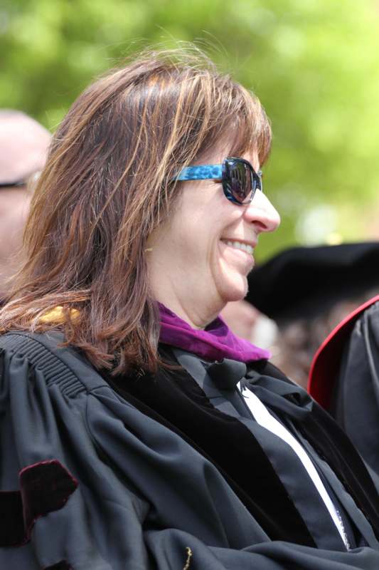 a woman wearing a black robe and sunglasses