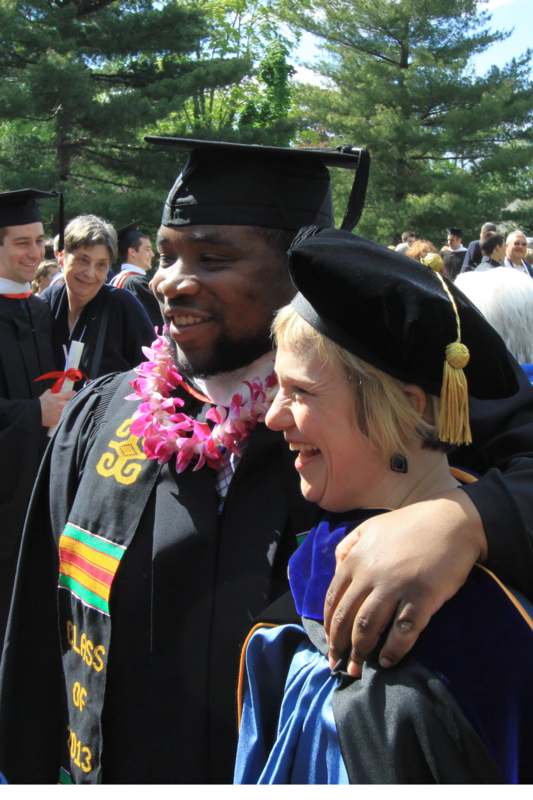 a man and woman in graduation gowns and cap and gowns