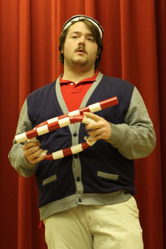 a man holding a red and white object