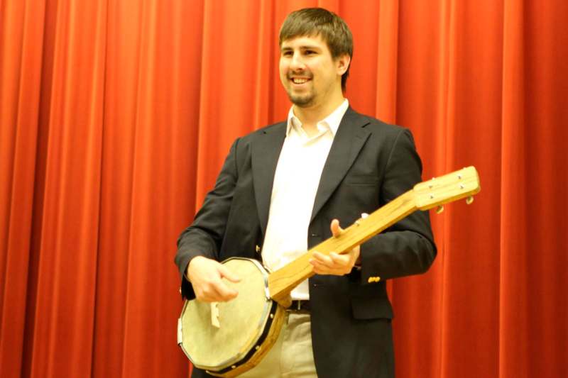 a man holding a banjo