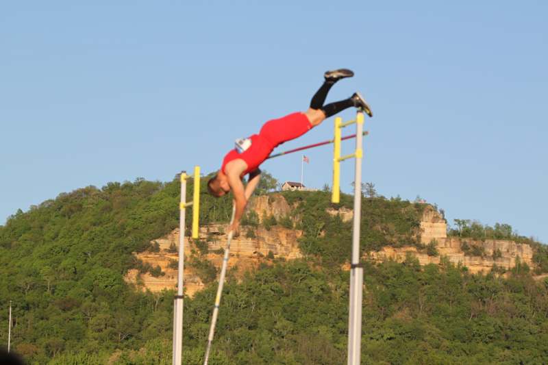 a man jumping over poles