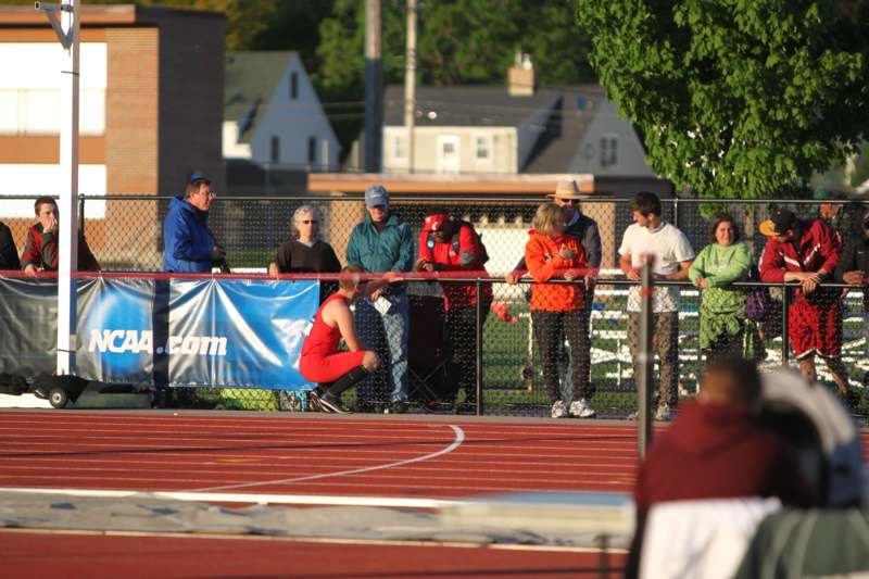 a person in a red uniform on a track