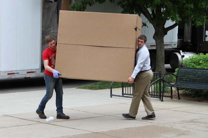 a man carrying a large box