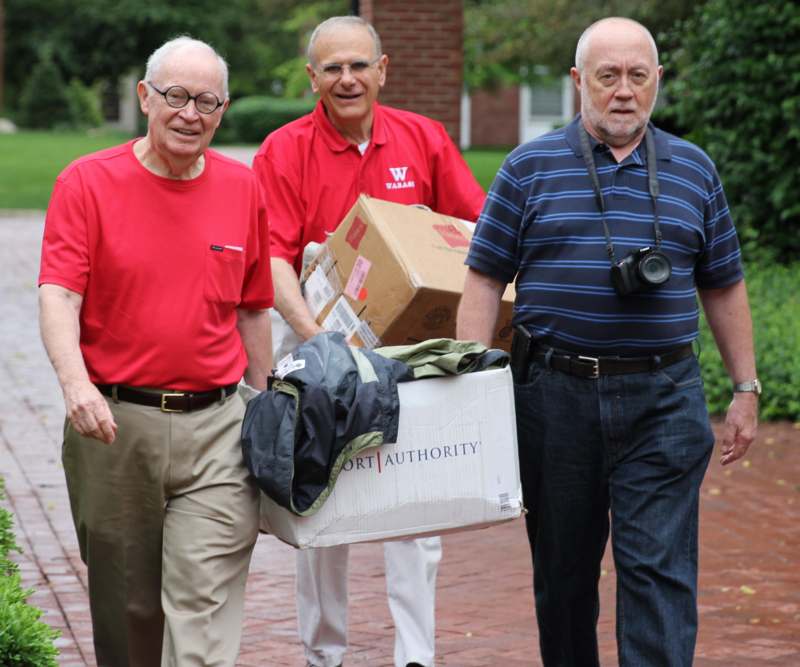 a group of men carrying boxes