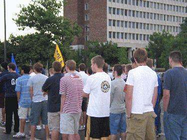 a group of people standing in a street