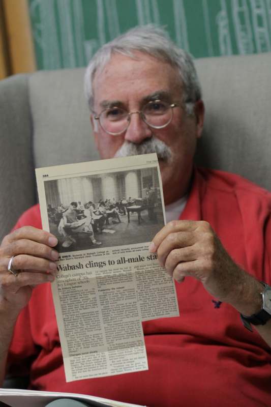 a man holding a newspaper
