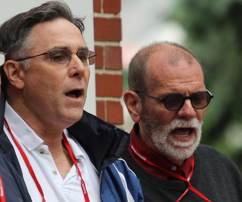two men wearing glasses and a lanyard