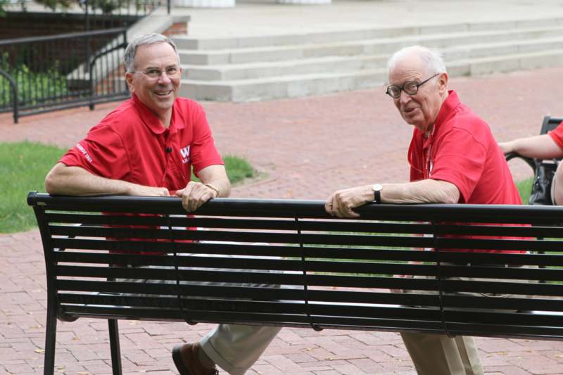 two men sitting on a bench