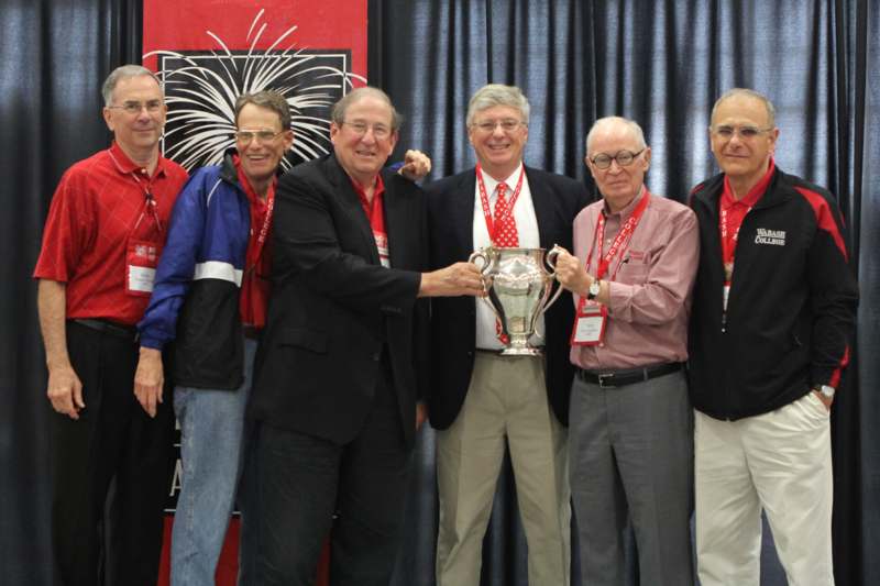 a group of men posing with a trophy
