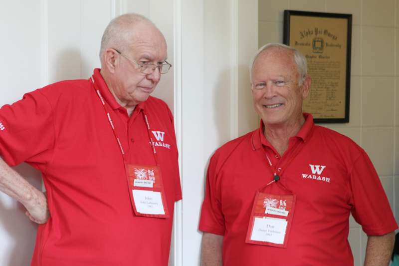 two men wearing red shirts