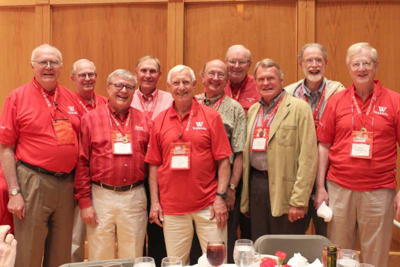 a group of men wearing matching red shirts