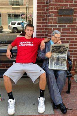 a man sitting on a bench with a newspaper