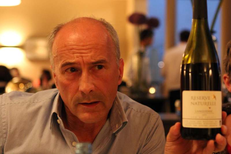 a man holding a bottle of wine