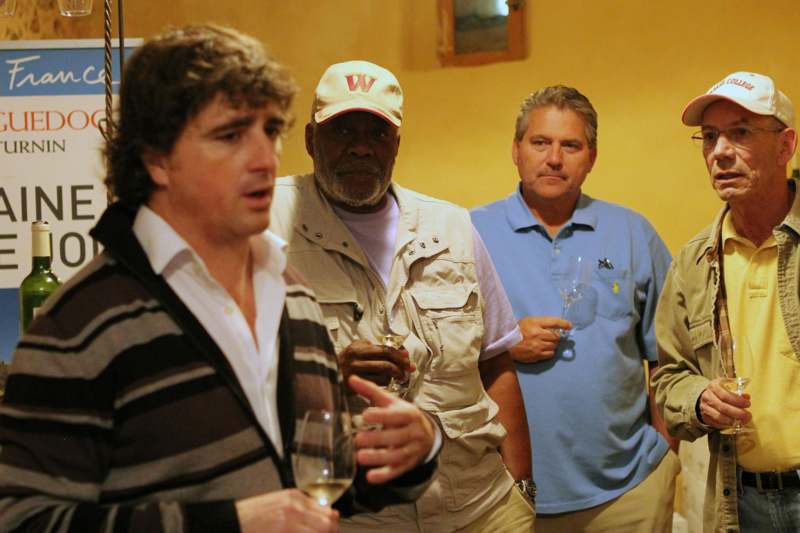 a group of men holding wine glasses