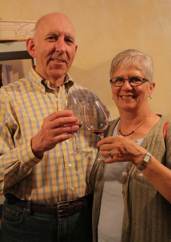 a man and woman holding wine glasses