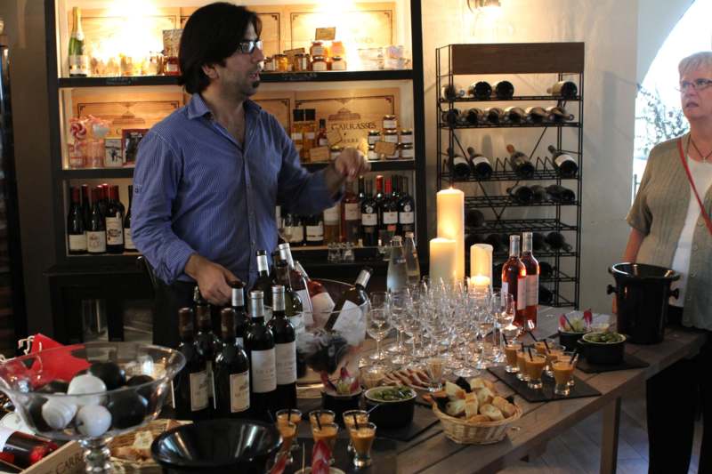 a man standing in front of a table full of wine glasses