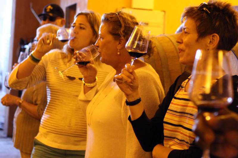 a group of people drinking wine