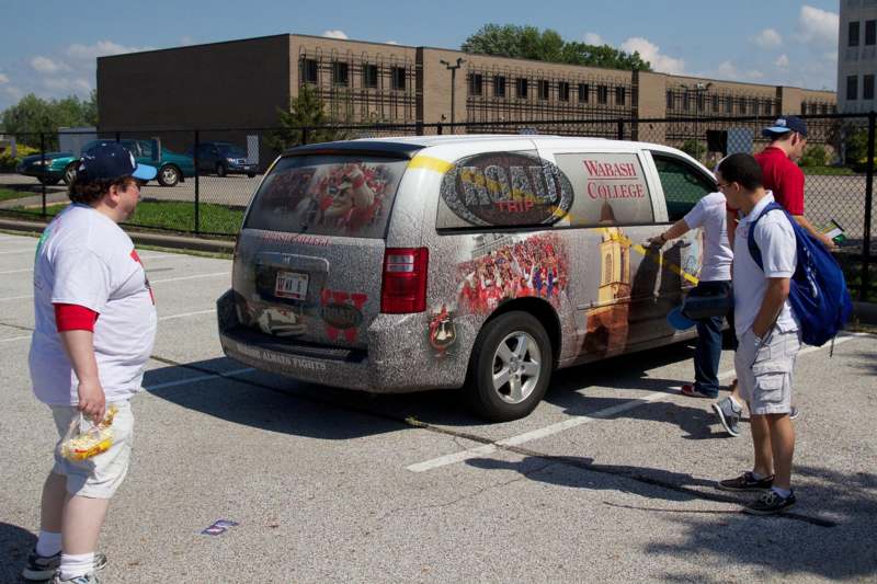 a group of people painting a van