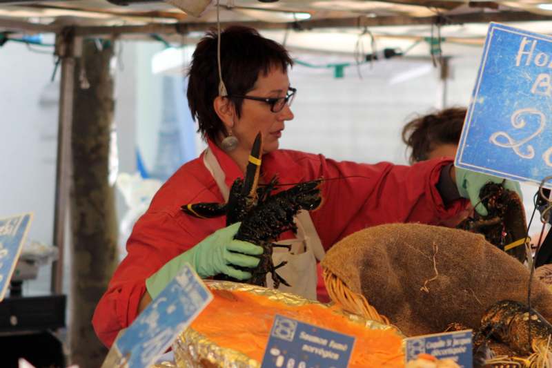 a woman holding a lobster