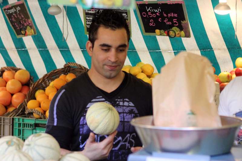 a man holding a melon
