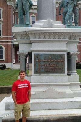 a man standing in front of a monument