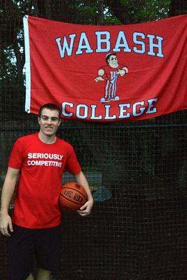 a man holding a basketball and a banner
