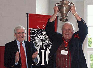 a group of men holding up a trophy