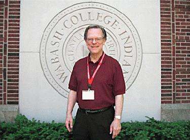 a man standing in front of a sign