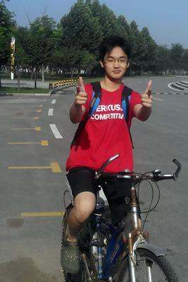 a boy on a bicycle giving thumbs up