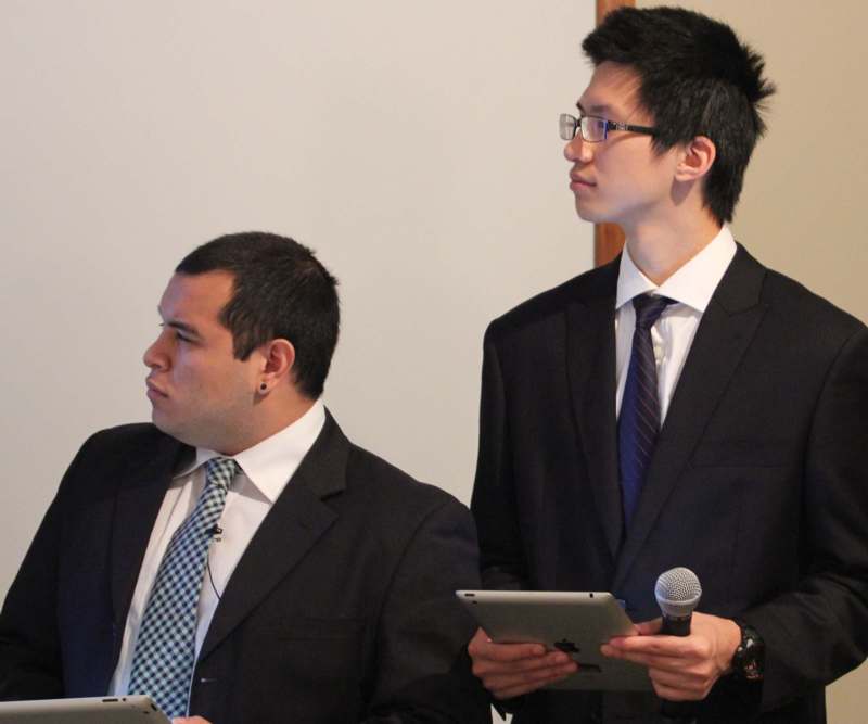 a group of men in suits holding devices and microphone