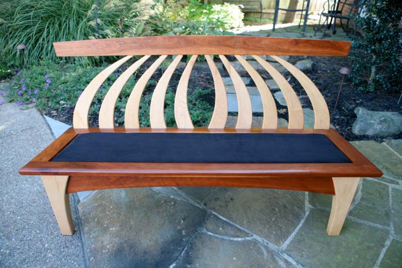a wooden bench with a cushion
