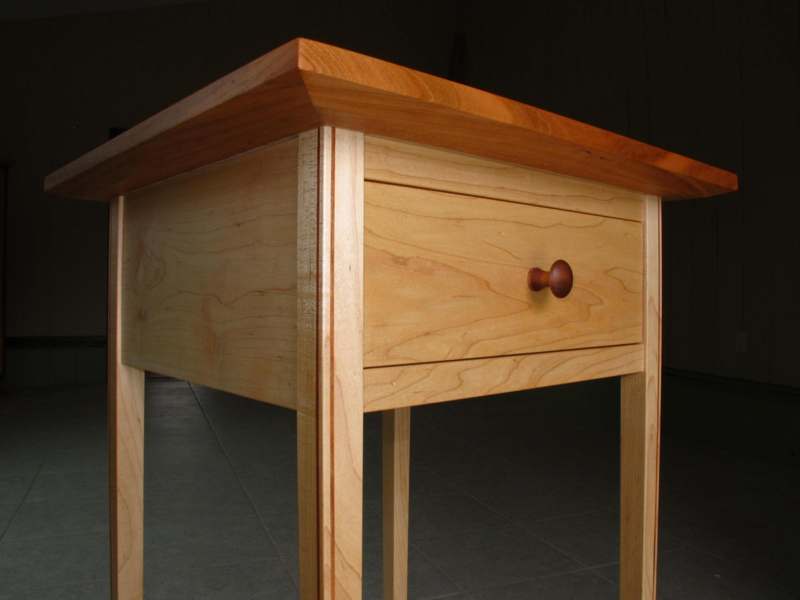 a wooden table with a drawer