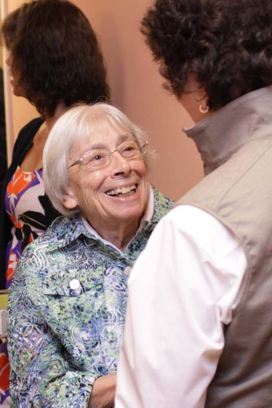 a woman smiling at another woman